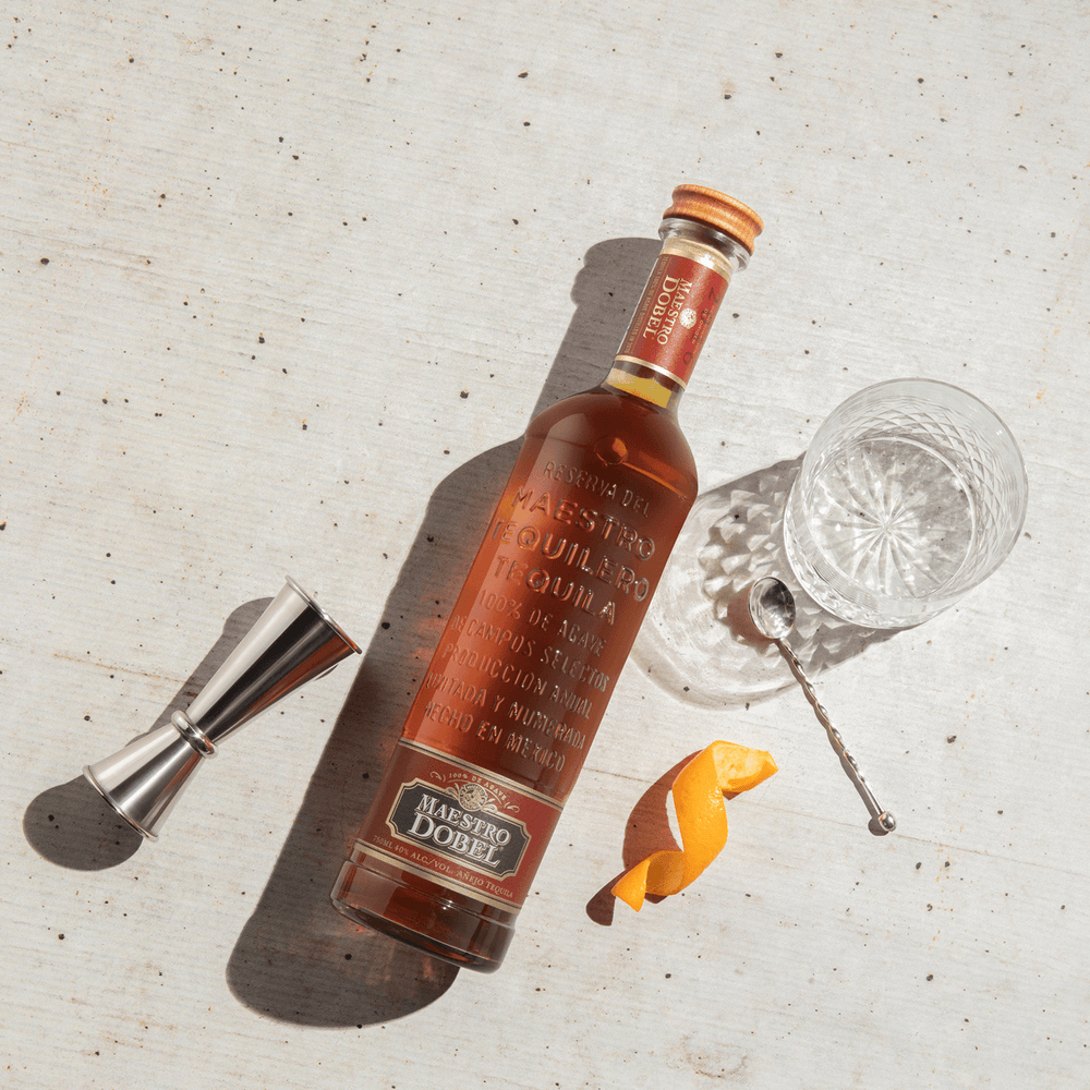 Dobel Añejo with cocktail tools.