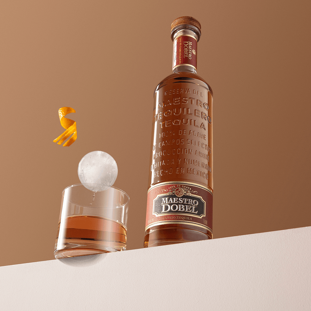 Dobel Añejo with ice sphere and orange twist.