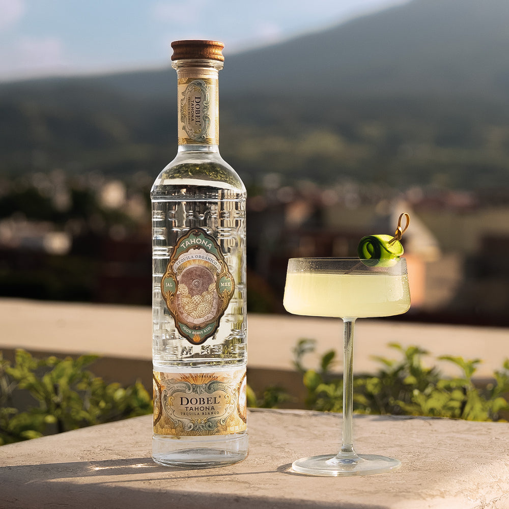 Dobel Tahona bottle next to cocktail.