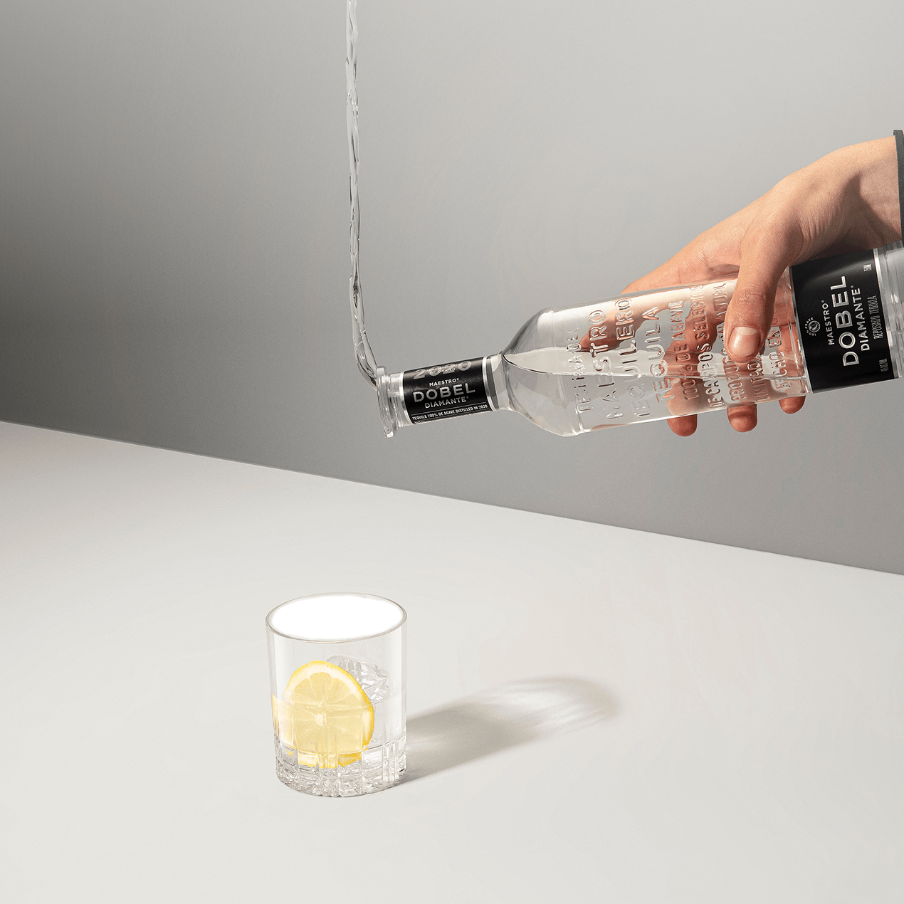 Dobel Diamante Cristalino bottle pouring into signature cocktail