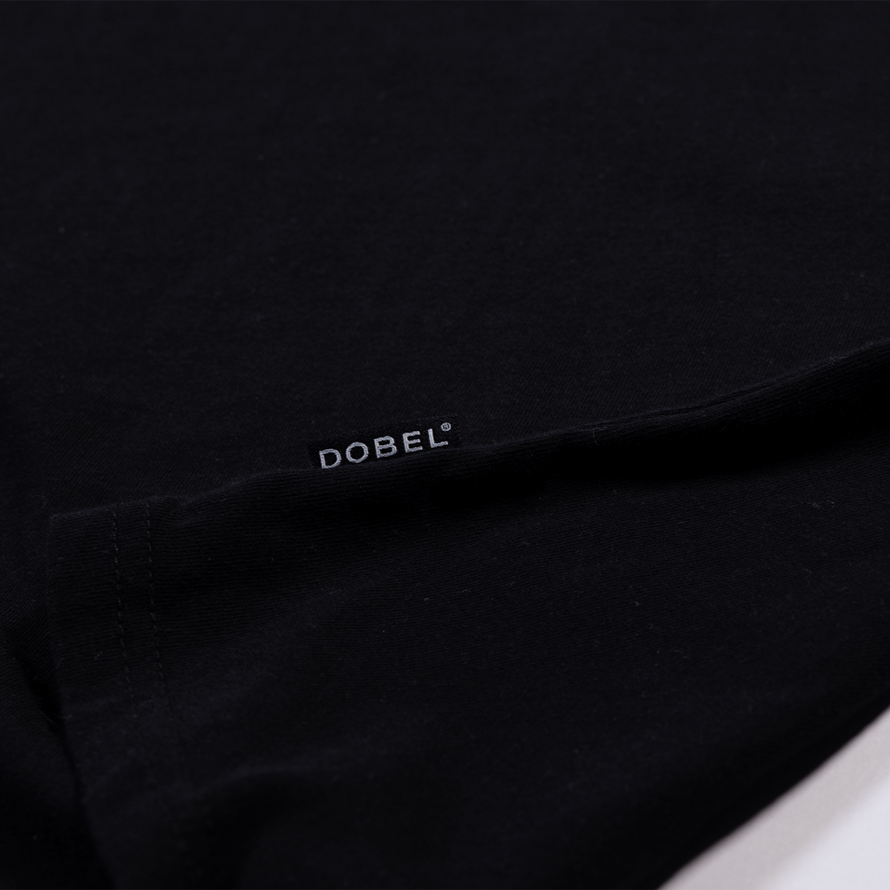 Close up detail of small Dobel tag logo.