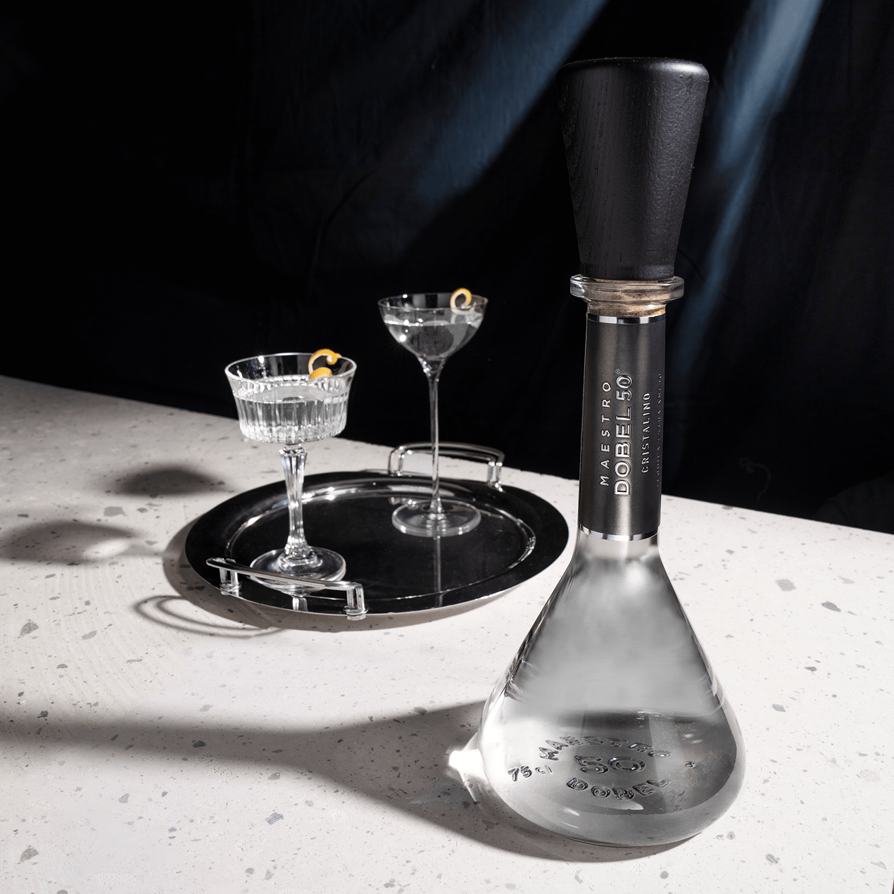 Dobel 50 Cristalino Extra Añejo highlights the intricate texture of its bottle cap and top design.
