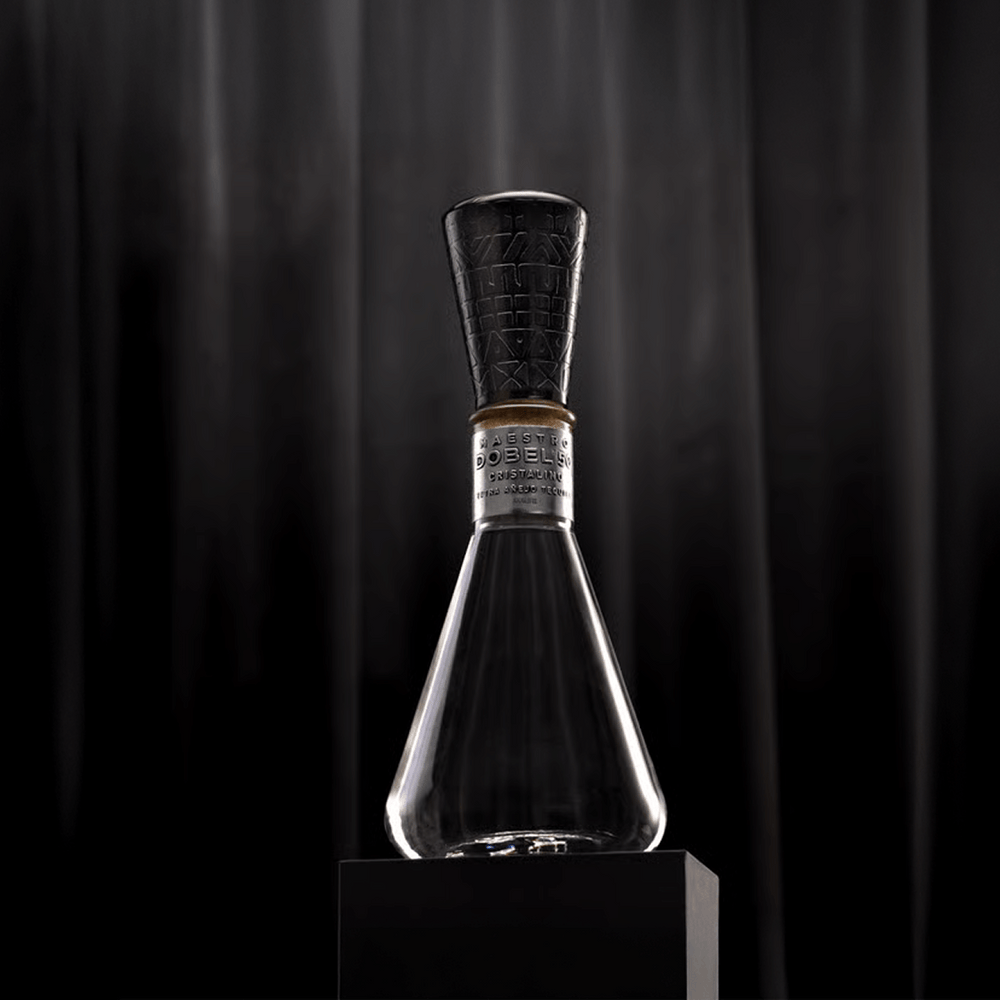 Dobel 50 Cristalino Onora Laca de Olinala elegant bottle on a black pedestal.