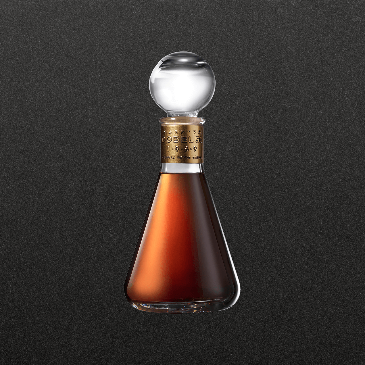 Dobel 50 Extra Añejo 1969 front of bottle with amber liquid and clear spherical cap.