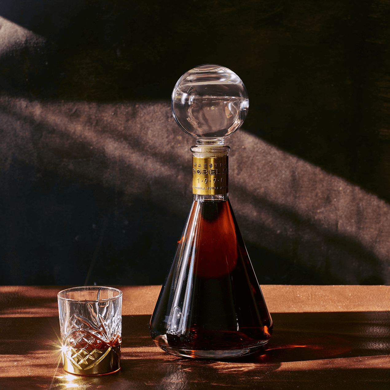 Dobel 50 Extra Añejo 1970 bottle with glass filled.