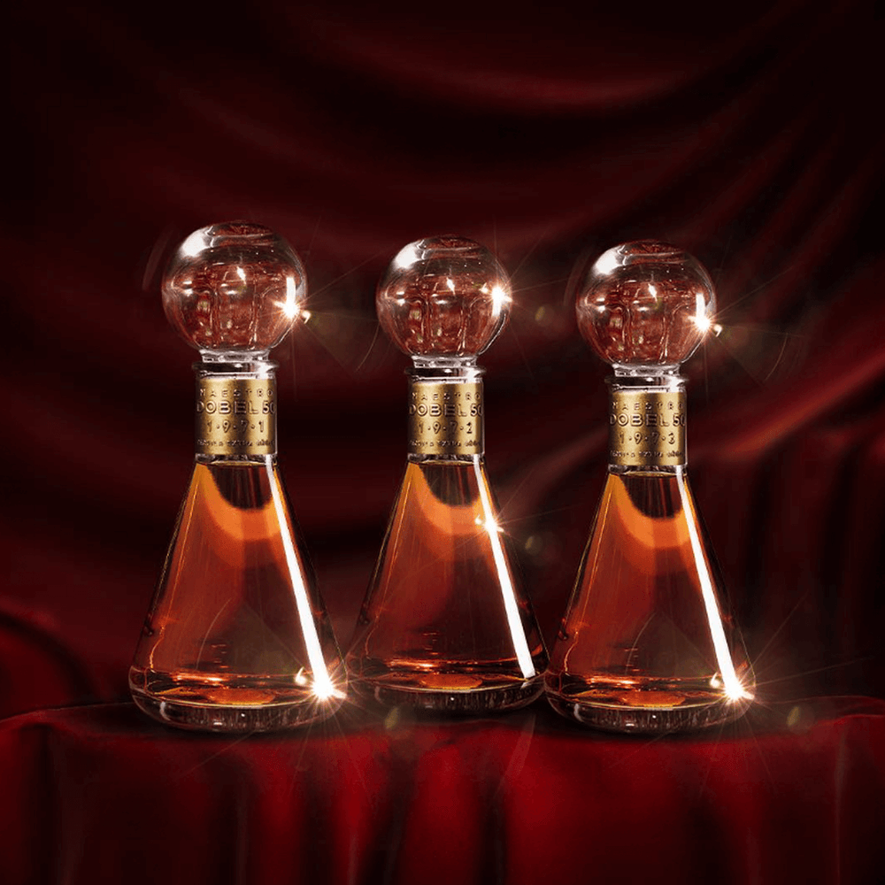 Dobel 50 Extra Añejo 1971 artistic trio bottle display.