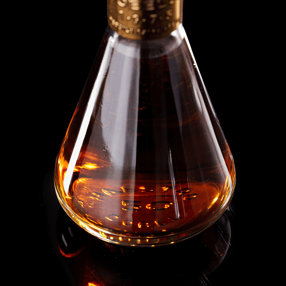 Close up of inside of Dobel 50 Extra Añejo 1975 bottle on black background.