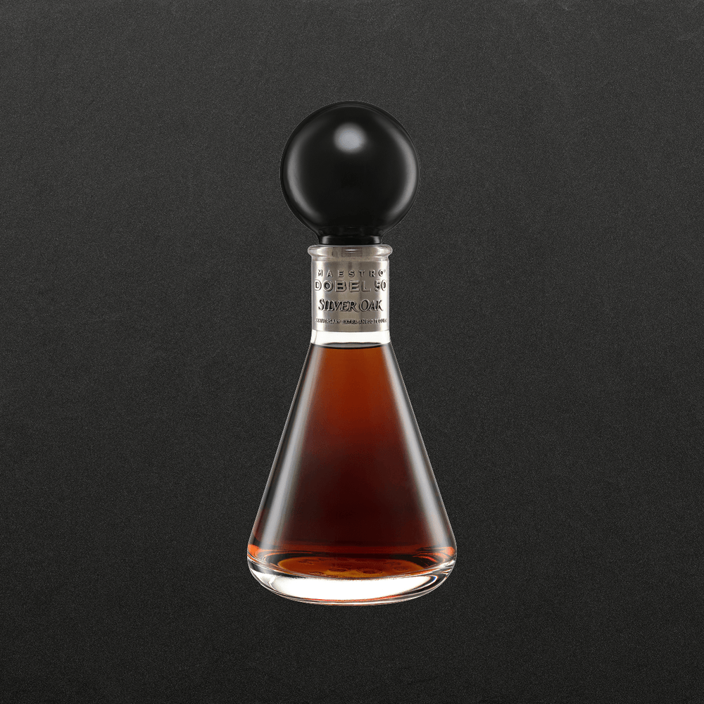 Dobel 50 Extra Añejo Silver Oak front of bottle with dark liquid and round cap.