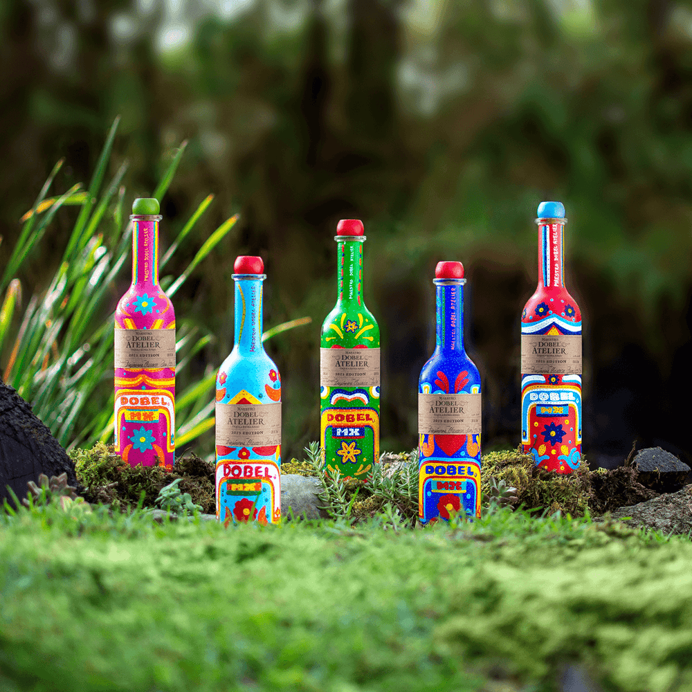 Dobel Atelier: Trajineras Edition five colorful bottles by the water.
