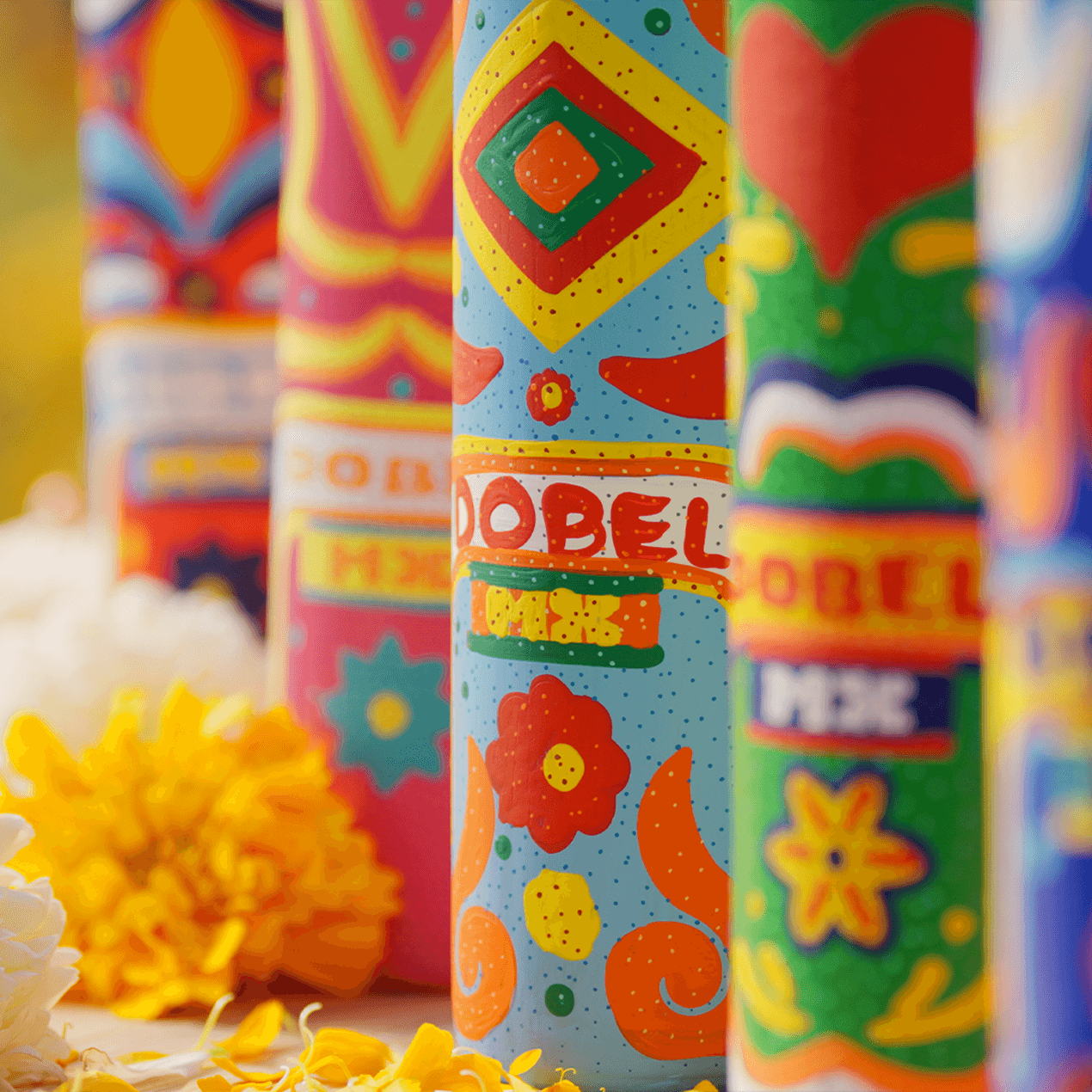 Dobel Atelier: Trajineras Edition close-up of colorful bottle designs with flowers.
