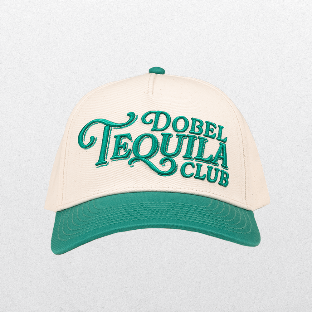 Front of snapback hat with Dobel Tequila Club lettering graphic.
